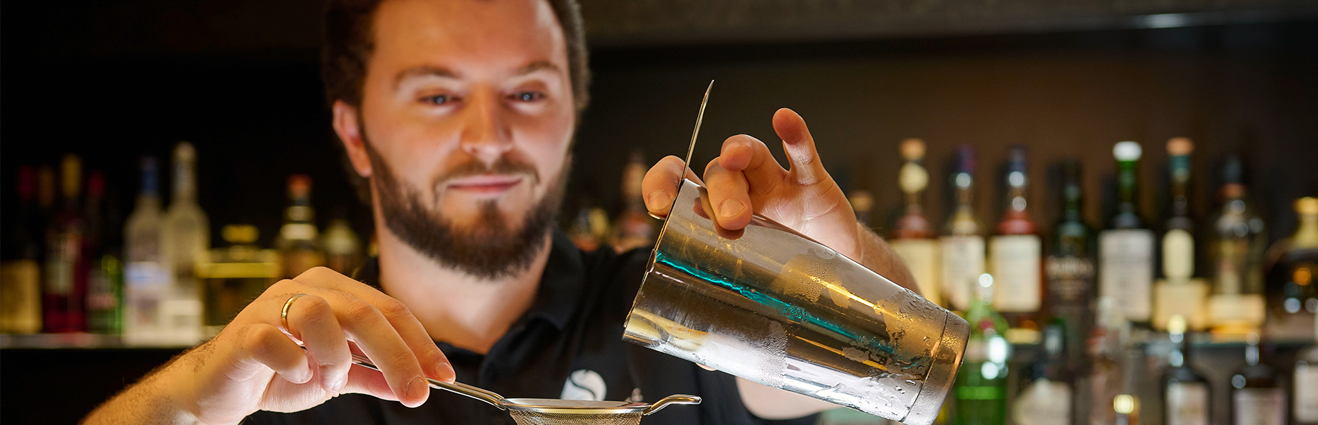 Bartender pours a cocktail into a glass at the 101 Bar in the SI-SUITES Hotel Stuttgart