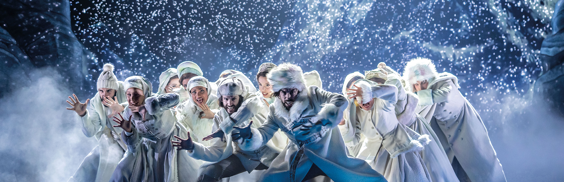 Group of singers on stage in a snowstorm