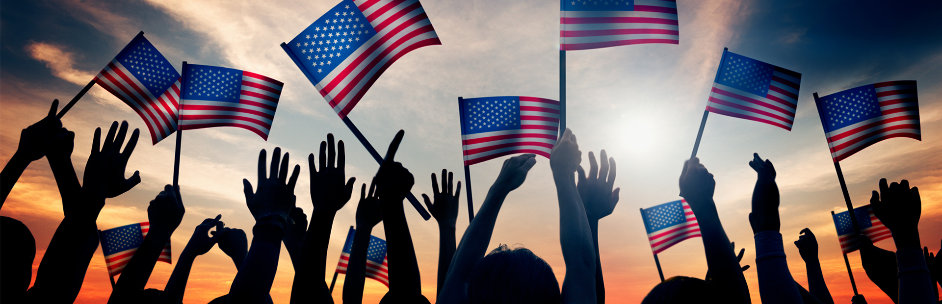 Crowd with American flags at sunset